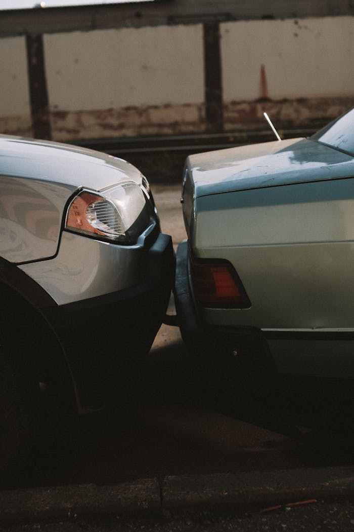about-us-02 A close-up view showing the aftermath of a rear-end car collision in an outdoor setting.